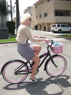 Riding her pink "Nirve" bike